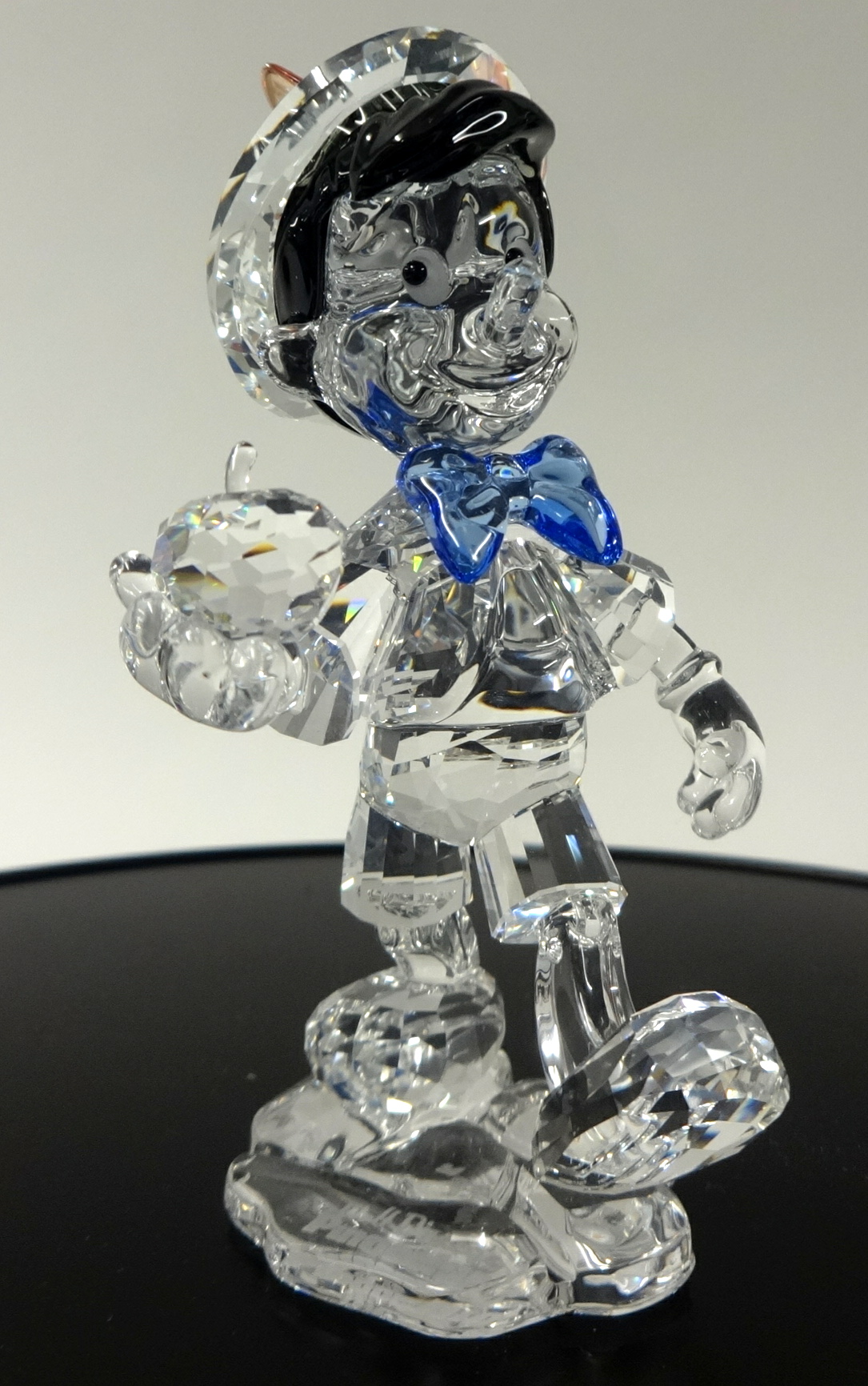 Swarovski Crystal glass Pinocchio 70 Anniversary and Jiminy cricket star on mirror stand.