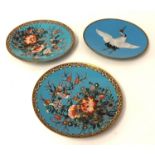 A pair of cloisonné plates decorated with birds together with a single plate decorated with a