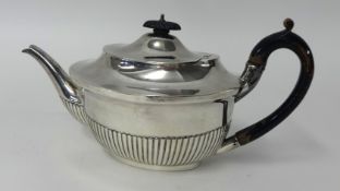 A silver teapot with half fluted body, weight approx.19oz