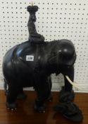 A large and heavy ebonised elephant, surmounted with a figure, and another loose figure.