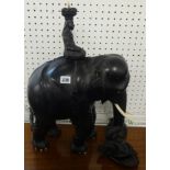 A large and heavy ebonised elephant, surmounted with a figure, and another loose figure.