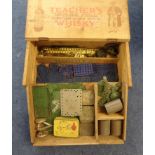 Collection of Meccano parts in wooden box including plates, strips, cylindrical parts etc.