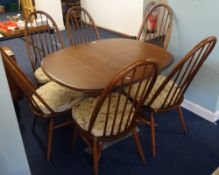 An Ercol dining table and six chairs.