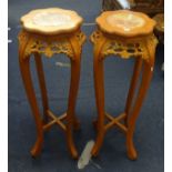 A pair of marble top and carved wood stands of Chinese design.