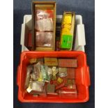 A large collection of Meccano parts including plates, strips, brackets , cylindrical parts, tins