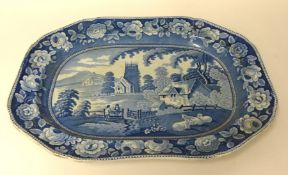 A Victorian blue and white platter decorated with a landscape scene.