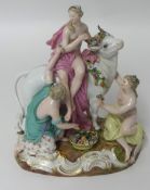 A German porcelain group of three maidens and a cow, with underglaze blue cross swords mark.