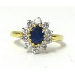 An 18ct sapphire and diamond cluster ring, circa 1990, size R.