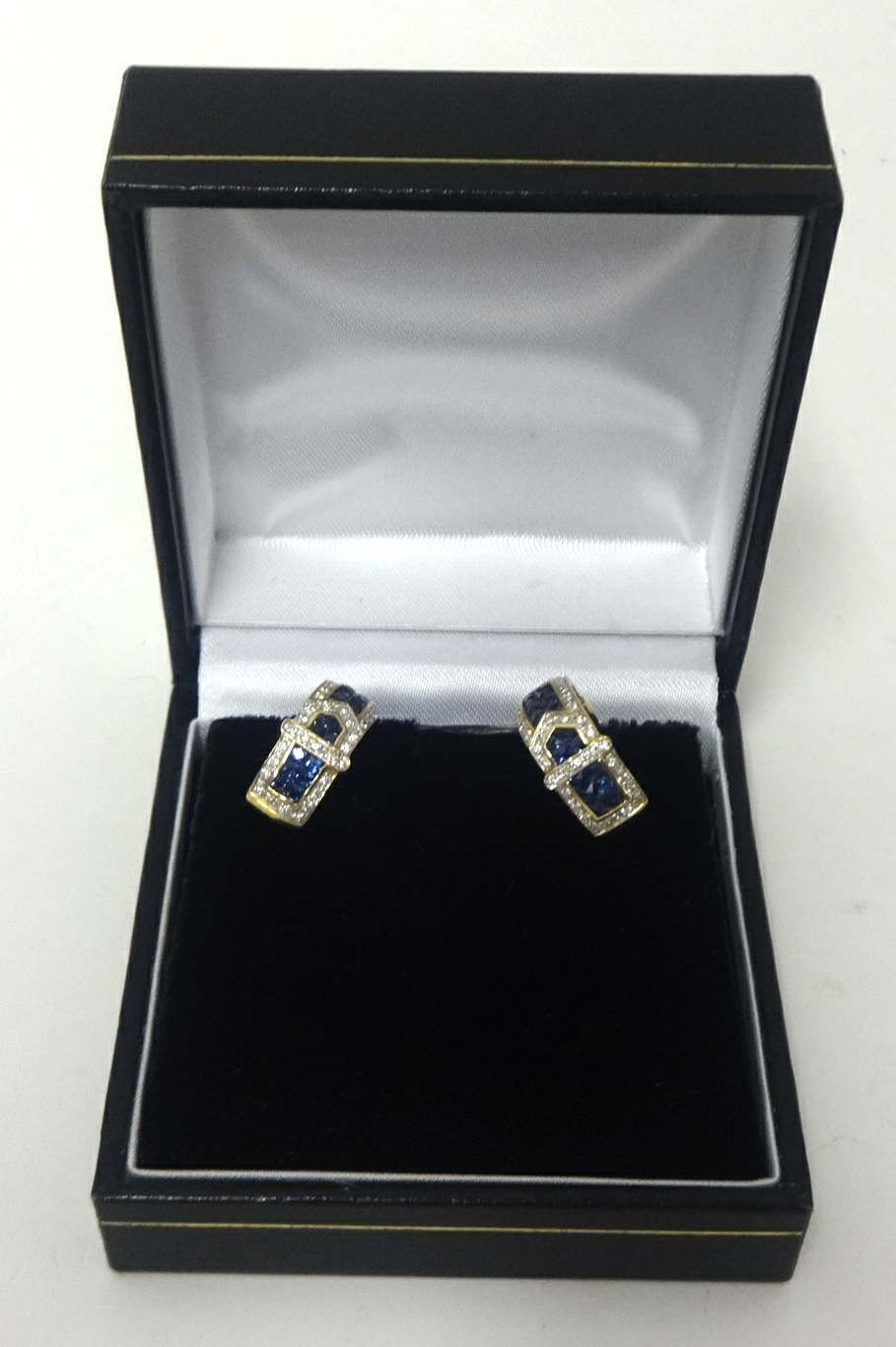 A pair of sapphire and diamond hoop 'buckle' earrings set in yellow gold.