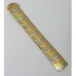 An 18K bracelet made in Italy, yellow, white and rose gold, approx 53.70g, 20cm x 2.50cm.