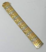 An 18K bracelet made in Italy, yellow, white and rose gold, approx 53.70g, 20cm x 2.50cm.