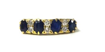 An 18ct antique sapphire and diamond ring, set with 4 blue sapphires and 8 bright old cut