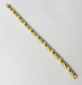 A diamond set yellow gold bracelet stamped .750, Pave set diamond sections, 19cm, approx. 25.5g.