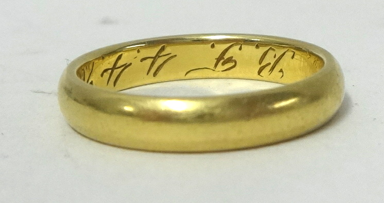 An 18ct gold wedding band, stamped .750, approx 4.10g.