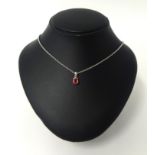 An 18ct white gold set pink topaz single stone pendant with a 9ct white gold belcher style necklet