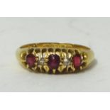 An 18ct ruby and diamond set ring, size M.