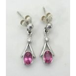 A pair of 18ct white gold and pink sapphire set earrings.