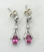 A pair of 18ct white gold and pink sapphire set earrings.