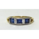 A sapphire and diamond ring, set with 3 square cut blue sapphires and 2 baguette cut diamonds,