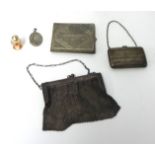 A small silver bag, an evening 'chain mail' bag, locket and miniature scent bottle.