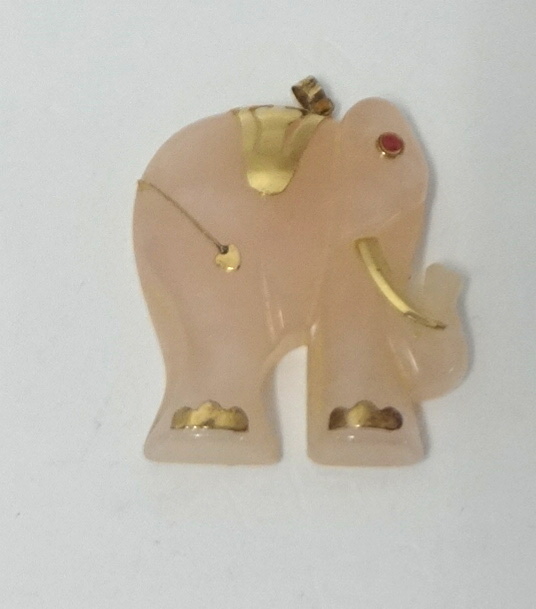 A rose quartz elephant set with a ruby eye, height 35mm.