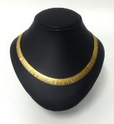 An 18ct gold, three colour, fringe necklace, approx 38.80g.