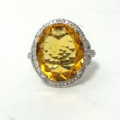A 14K white gold and diamond ring set with an oval cut golden beryl approx 9ct, diamonds approx 0.