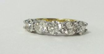 An 18ct yellow and white gold diamond set half Eternity Ring, five round brilliant cut diamonds,