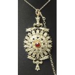A fine antique diamond set pendant with central ruby set with approximately 50 various round and