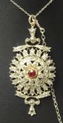A fine antique diamond set pendant with central ruby set with approximately 50 various round and