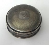 A silver circular snuff box, fitted with a mirror.
