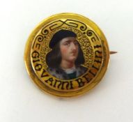A small yellow metal antique brooch with enamel portrait, titled, Giovanni Bellini.