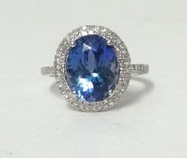 A 14K white gold and diamond ring set with an oval cut tanzanite, approx 4ct, diamonds approx 0.50ct