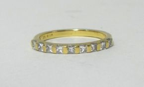 AN 18ct half band eternity ring set with princess cut diamonds, size K.