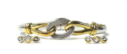 A 9ct gold, silver and diamond set hinged bangle, the two colour knot front set with single cut