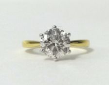 An 18ct yellow and white gold set diamond solitaire ring,