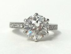 A platinum and large diamond single stone ring, claw set with one old brilliant cut diamond,