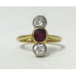 An 18ct gold diamond and ruby set three stone ring, size H.