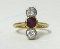An 18ct gold diamond and ruby set three stone ring, size H.
