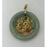 A Jadeite pendant set with gold dragon mounted with coloured stones, 35mm,