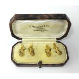 A pair of yellow gold cufflinks in the shape of Pistols, stamped .750, cased 7.9g.