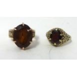 A 9ct garnet set ring and another possibly rose gold (2).