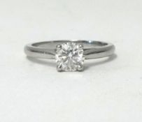 A fine platinum and diamond set solitaire ring, with single round brilliant cut diamond, claw set.