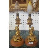 Pair of ormolu metal (possibly bronze) cherub lamps, height 18cm on later wood bases