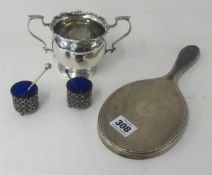 A pair of silver pierced table sales with glass liners, a silver back hand mirror and a silver