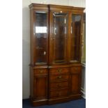 A modern walnut display cabinet, with glazed upper section, breakfront outline.