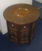 An Indian carved hardwood and inlaid occasional table (two sections), height 56cm.