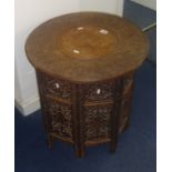 An Indian carved hardwood and inlaid occasional table (two sections), height 56cm.