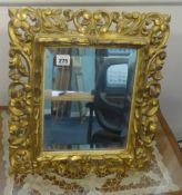 A carved and gilt wood table mirror of Italian style with bevelled plate, 48cm x 38cm.