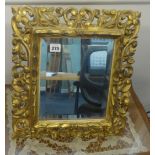 A carved and gilt wood table mirror of Italian style with bevelled plate, 48cm x 38cm.